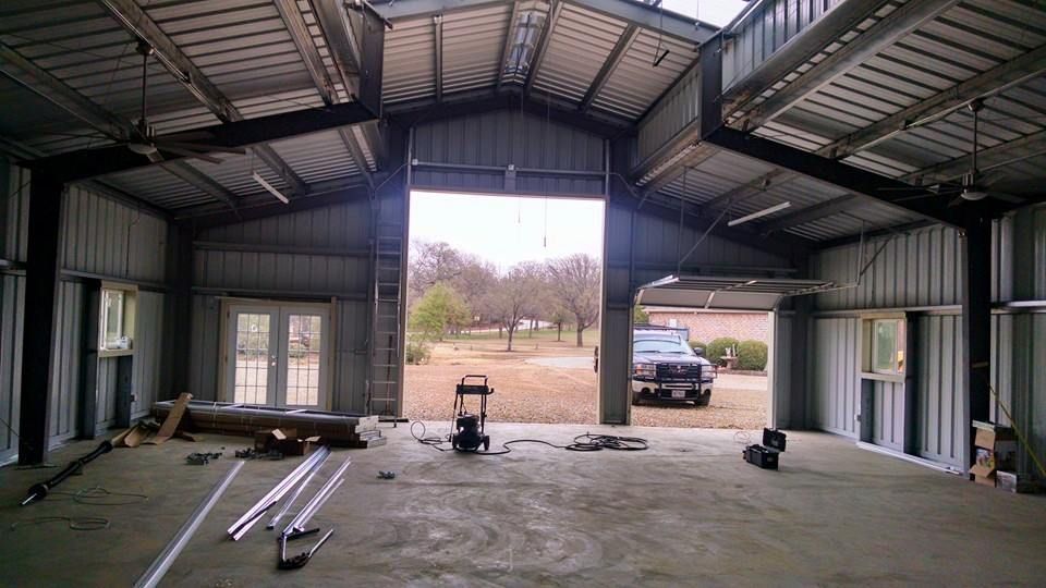 The inside of a garage with the door open and a truck parked in the driveway.