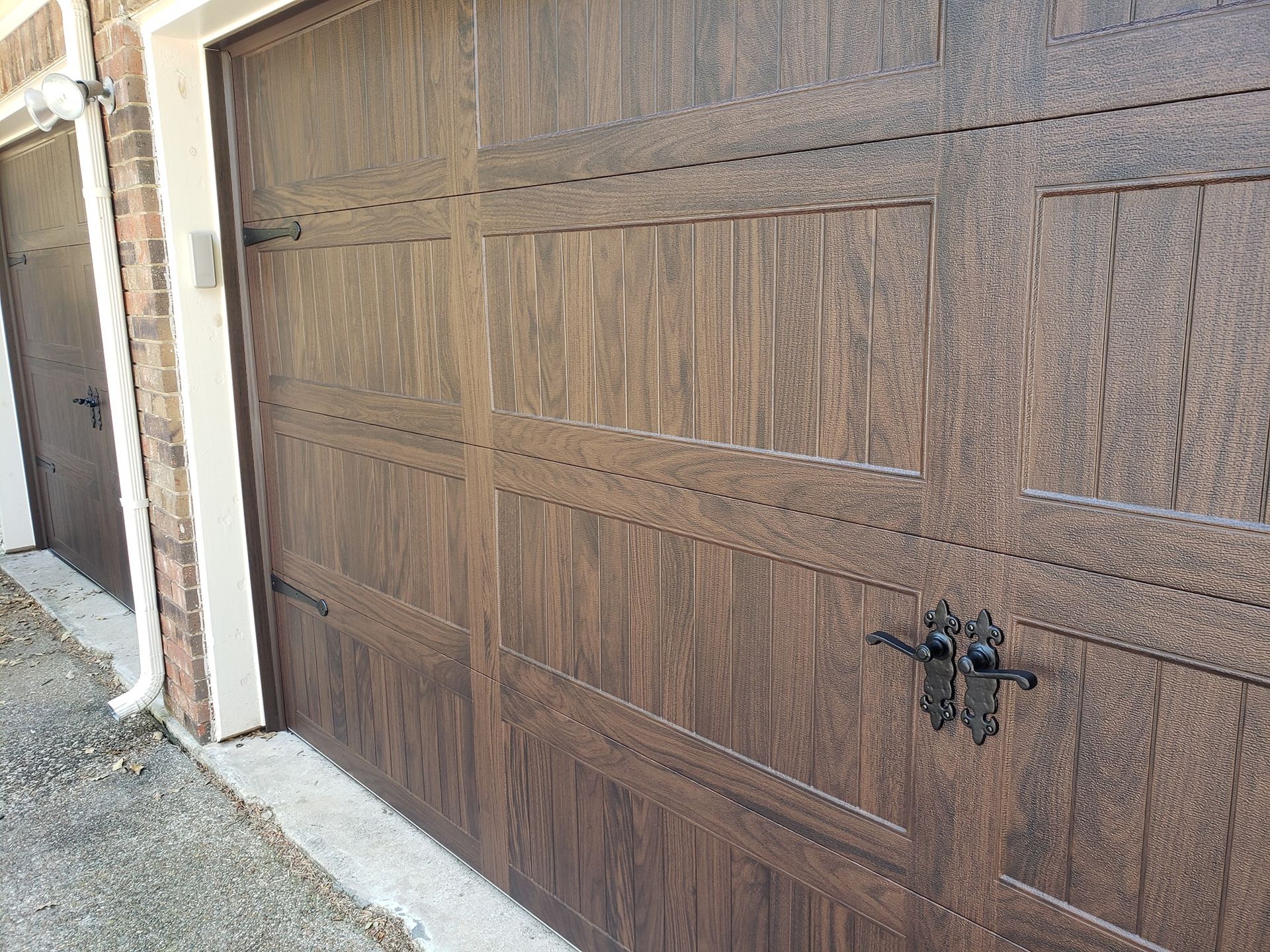 A close up of a wooden garage door on a house.