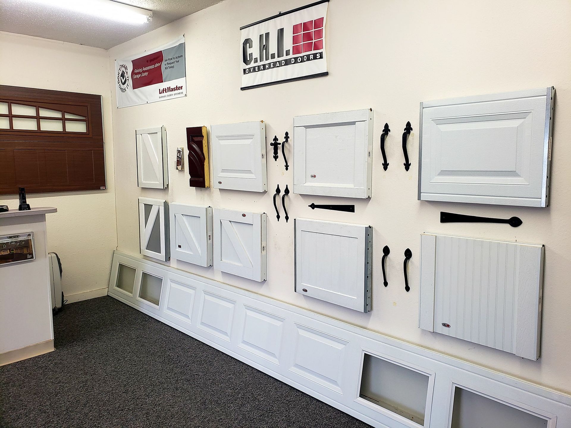 There are many different types of garage doors on display in this room.