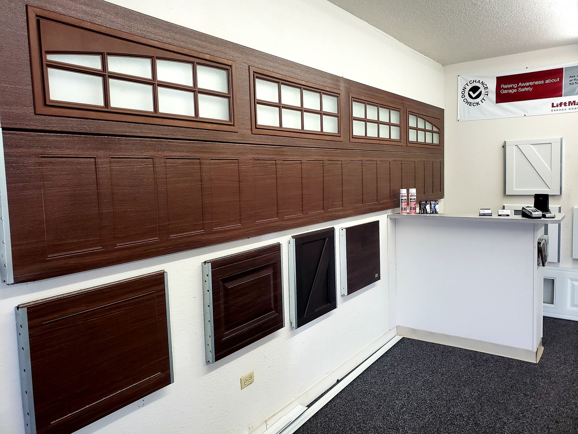 A room with a display of different types of garage doors
