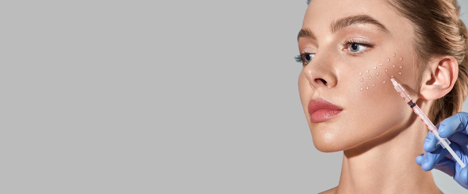 A woman is getting a botox injection in her face.