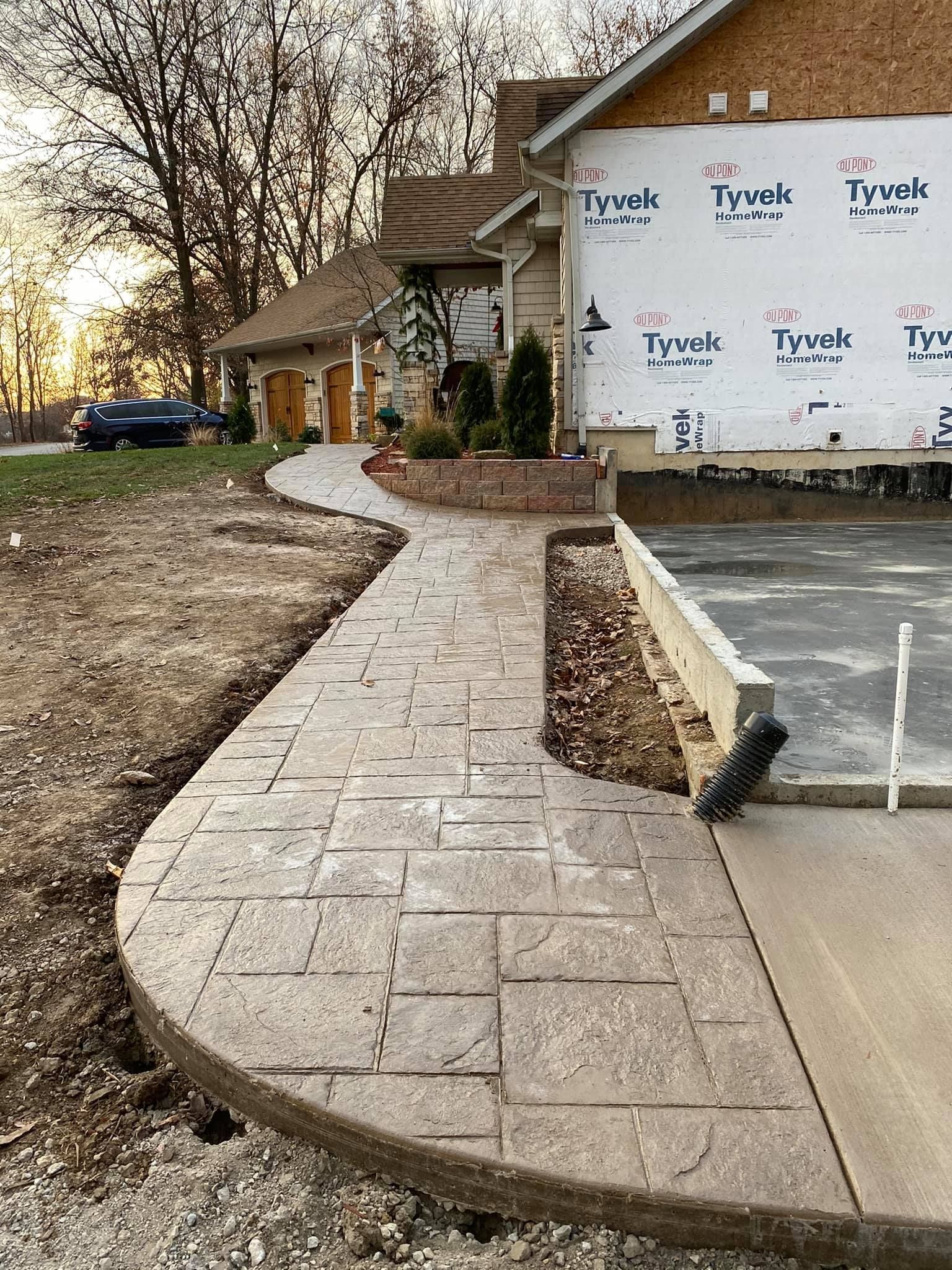 Window being cleaned with red squeegee; outdoors with green trees in background.