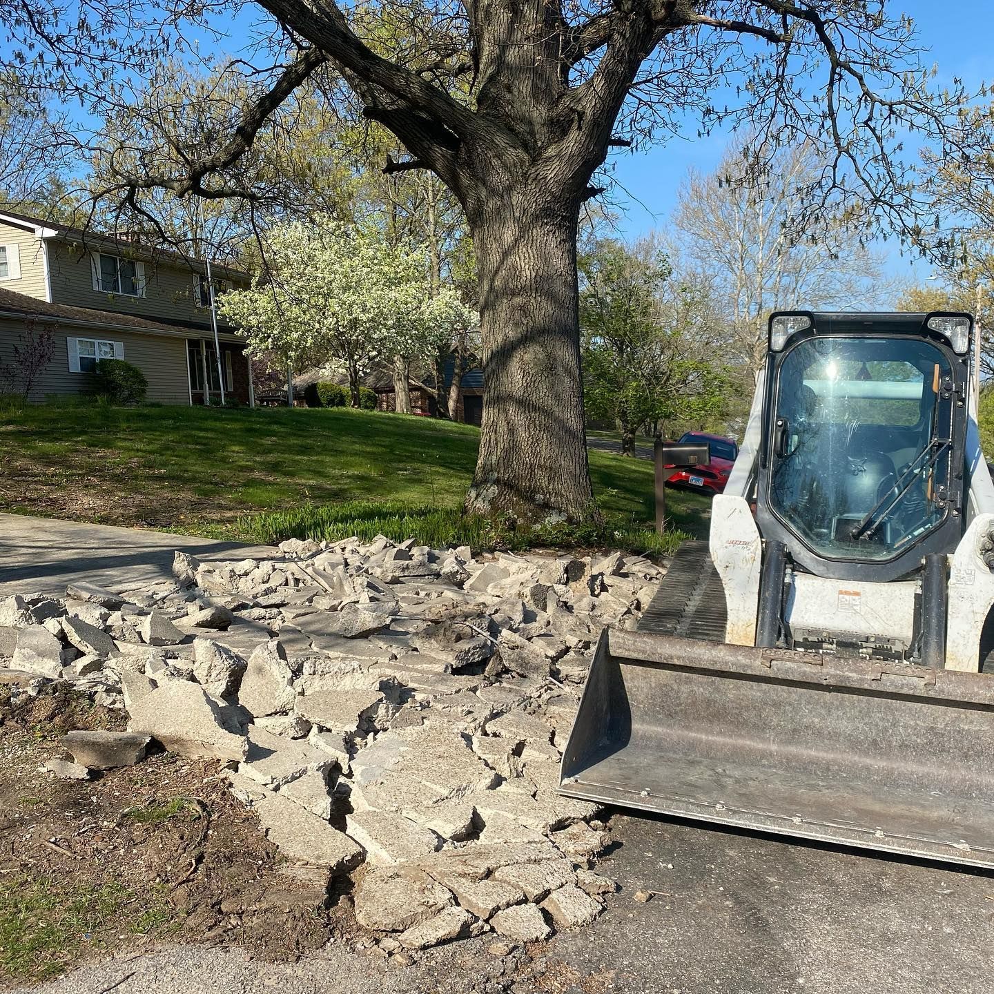 Window being cleaned with a long-handled brush, water spraying across the glass.