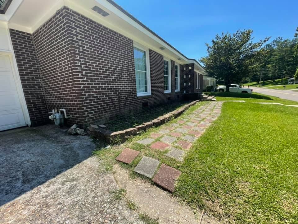 A brick house with a walkway leading to it.