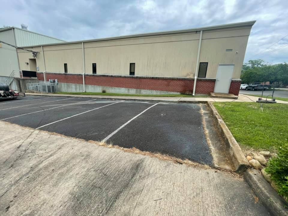 A large building with a parking lot in front of it.
