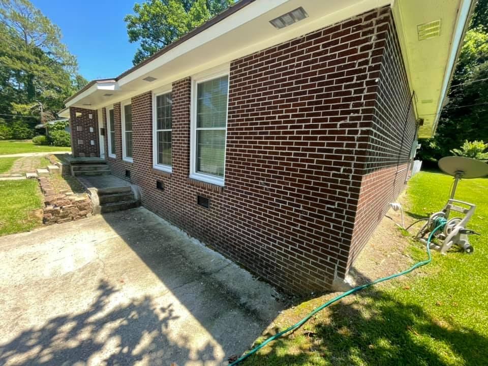 A brick house with a hose in front of it.