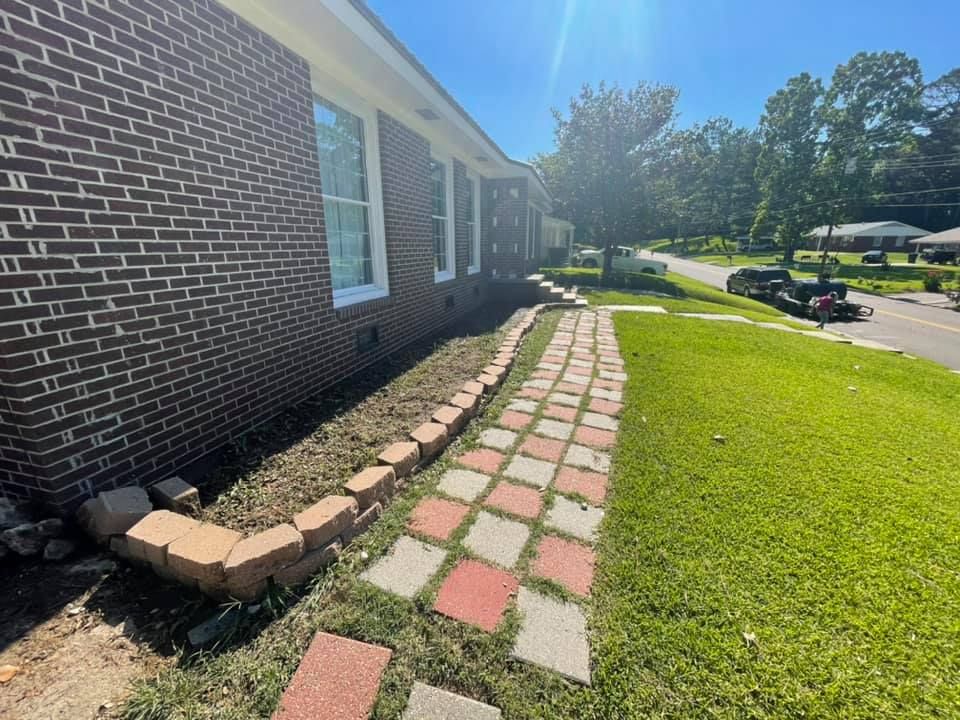 A brick house with a brick walkway leading to it.