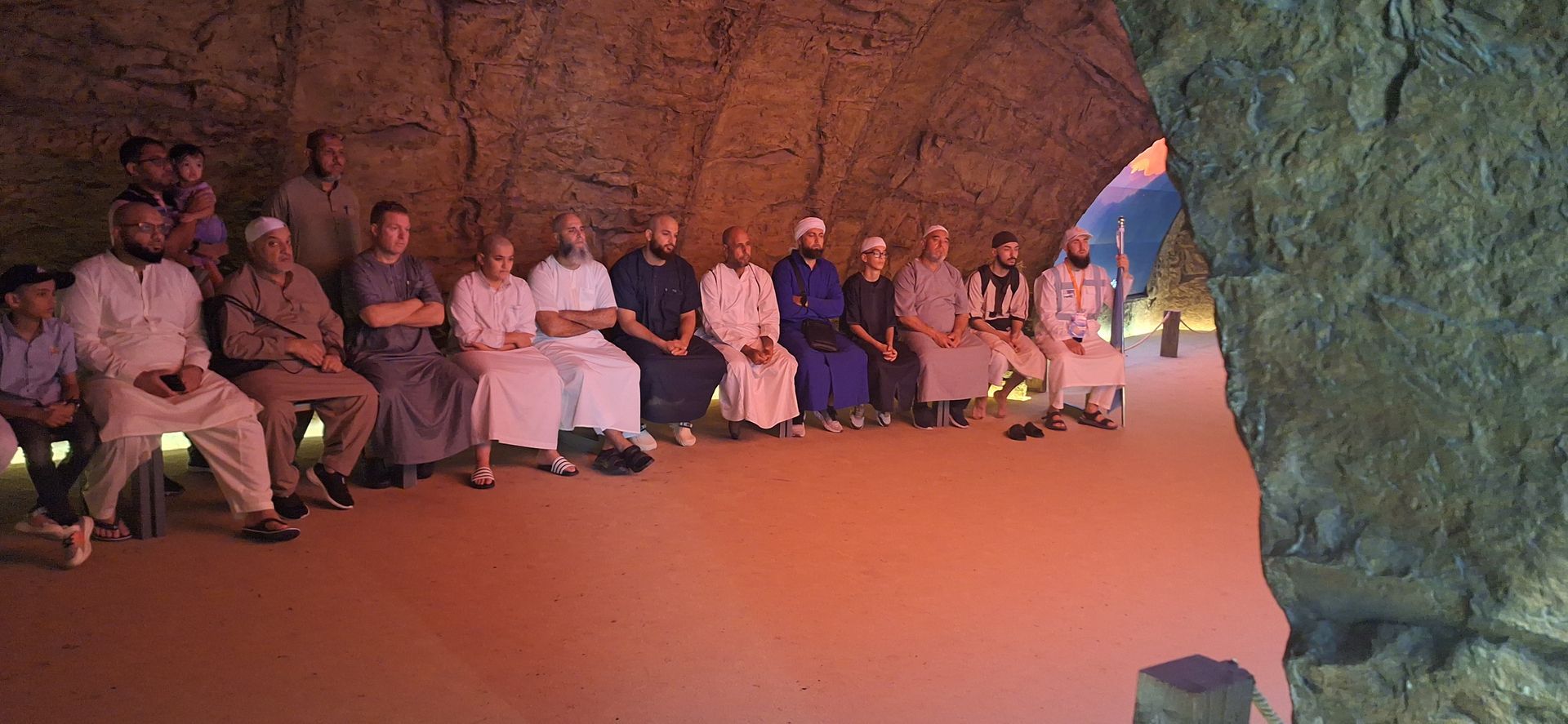 Een groep mensen zit in een grot.