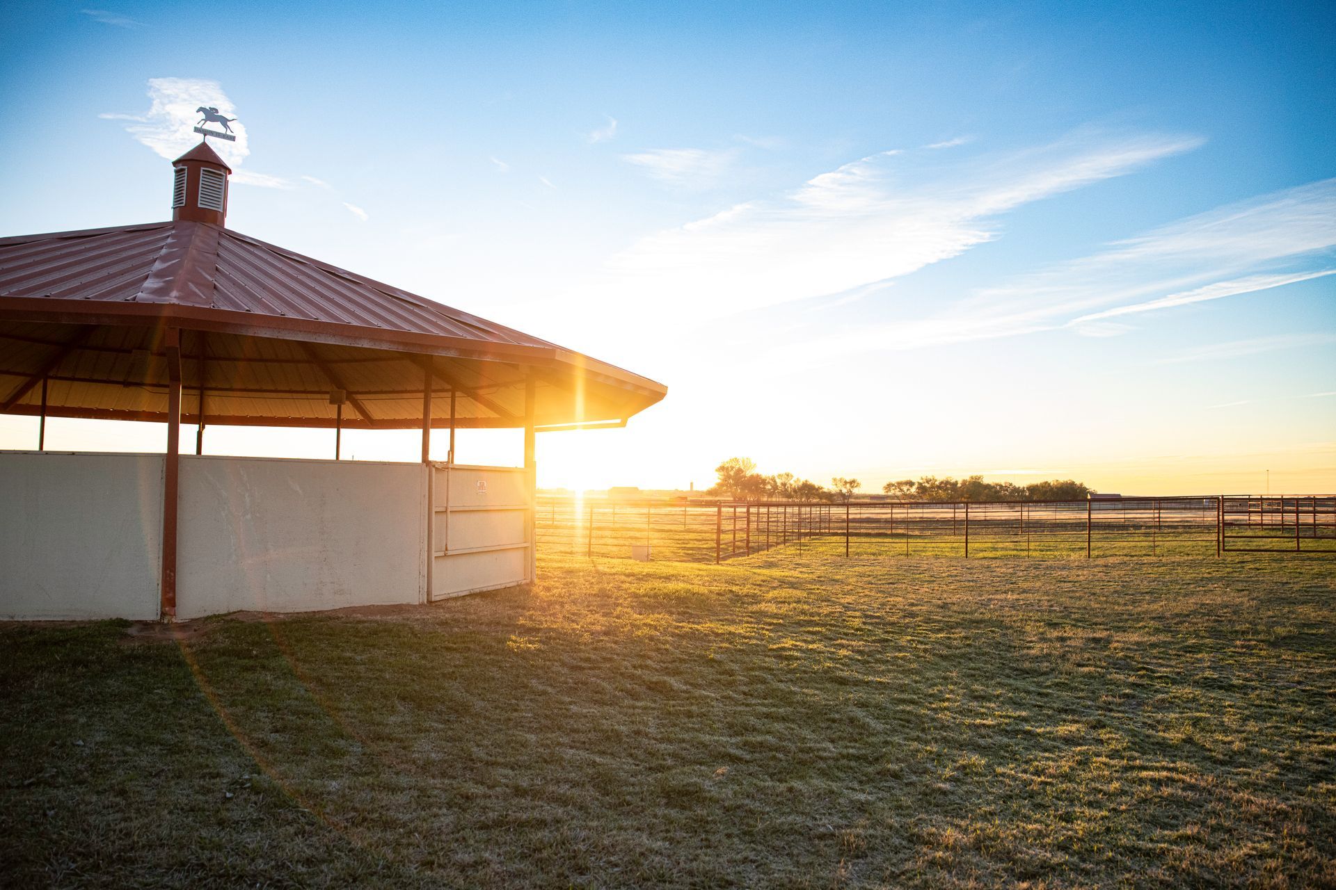 the sun is shining through the roof of a building in a field .