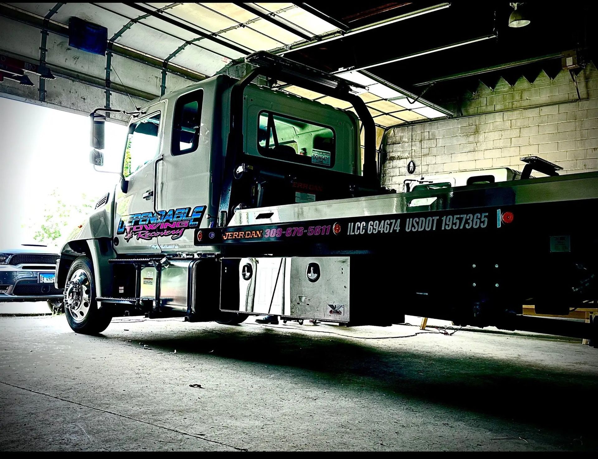 A tow truck is parked in a garage with the word chicago on the side