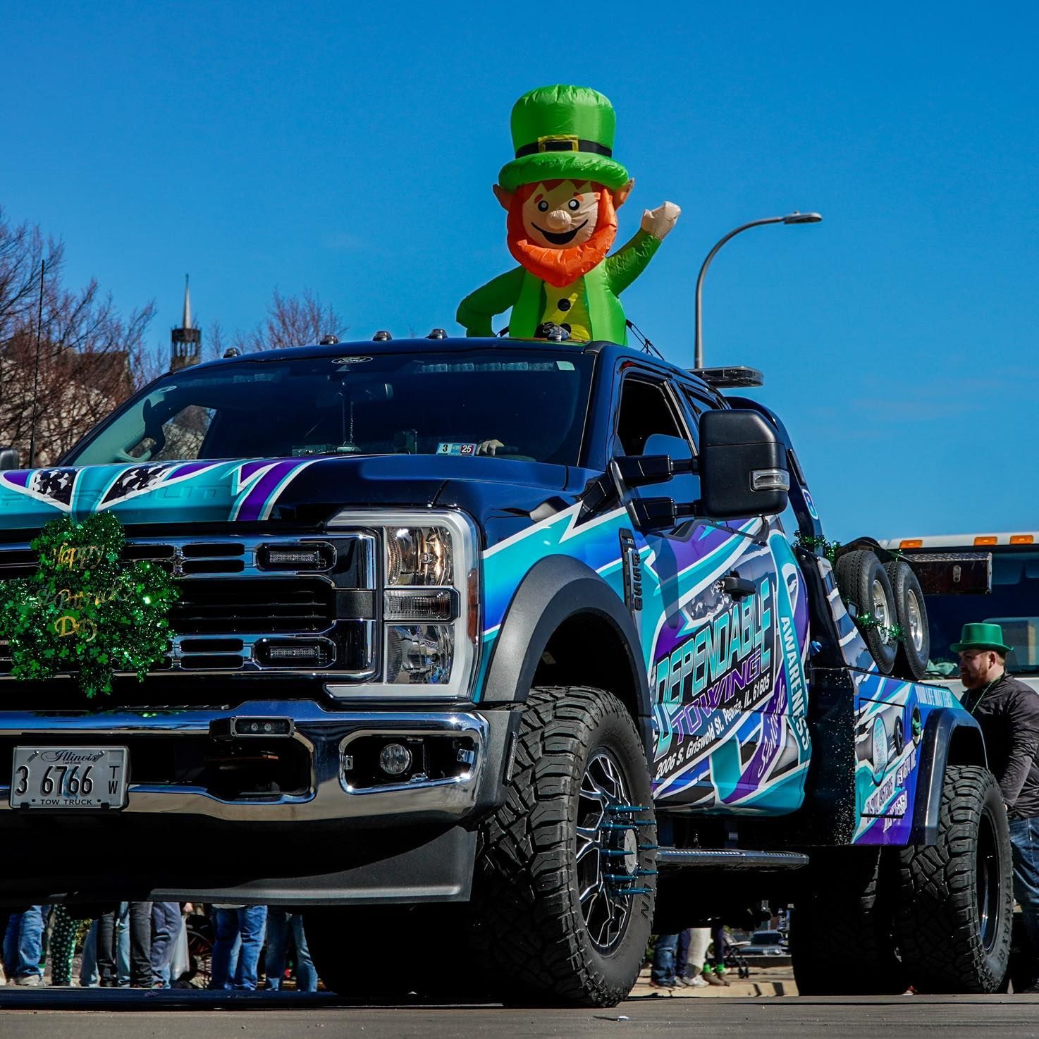 A truck with a leprechaun on top of it