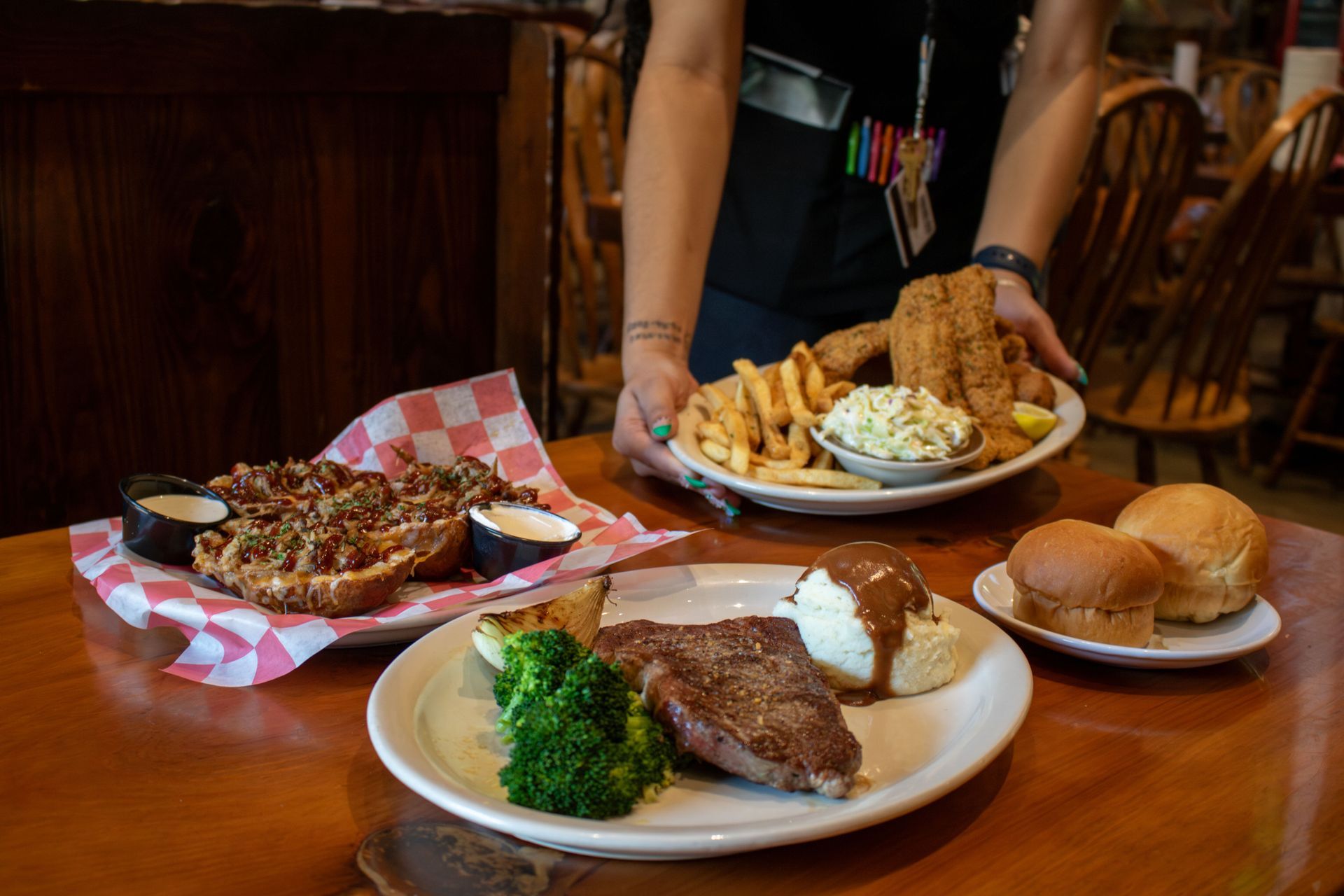Two bowls of pulled pork and ribs on a plate in a restaurant.