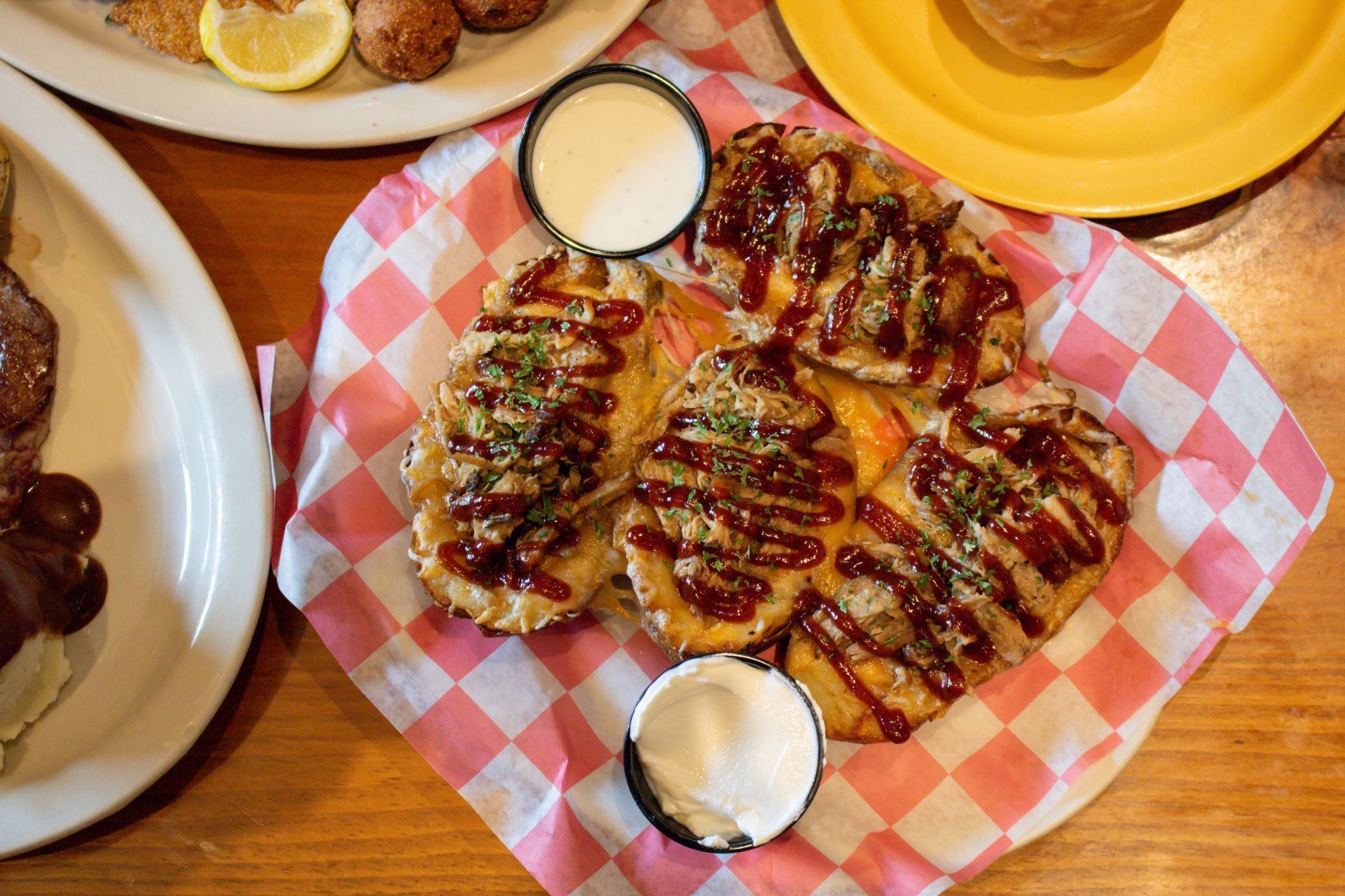 A plate of fried chicken with gravy and green beans on a table.