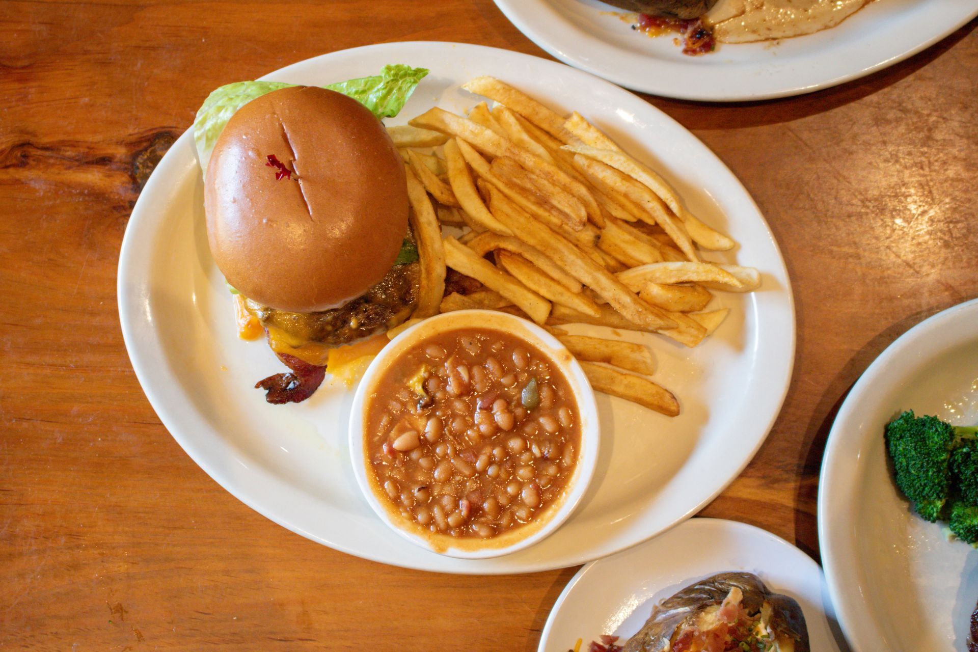 A plate of food with steak , shrimp and asparagus on a table.