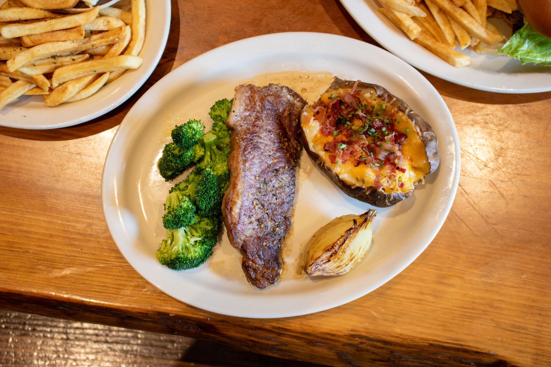 A white plate topped with salmon , rice and asparagus.