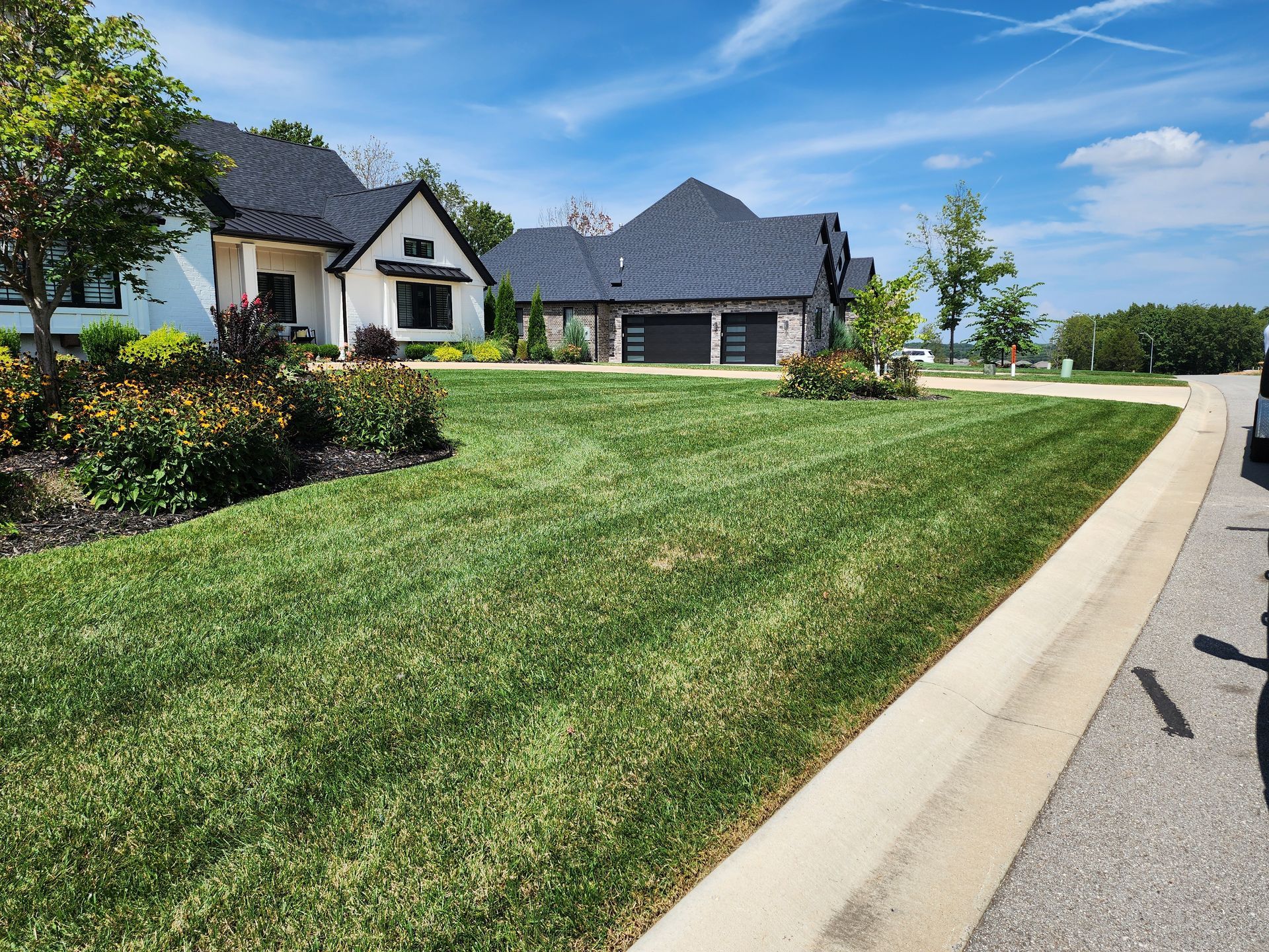 A large house with a lush green lawn in front of it.