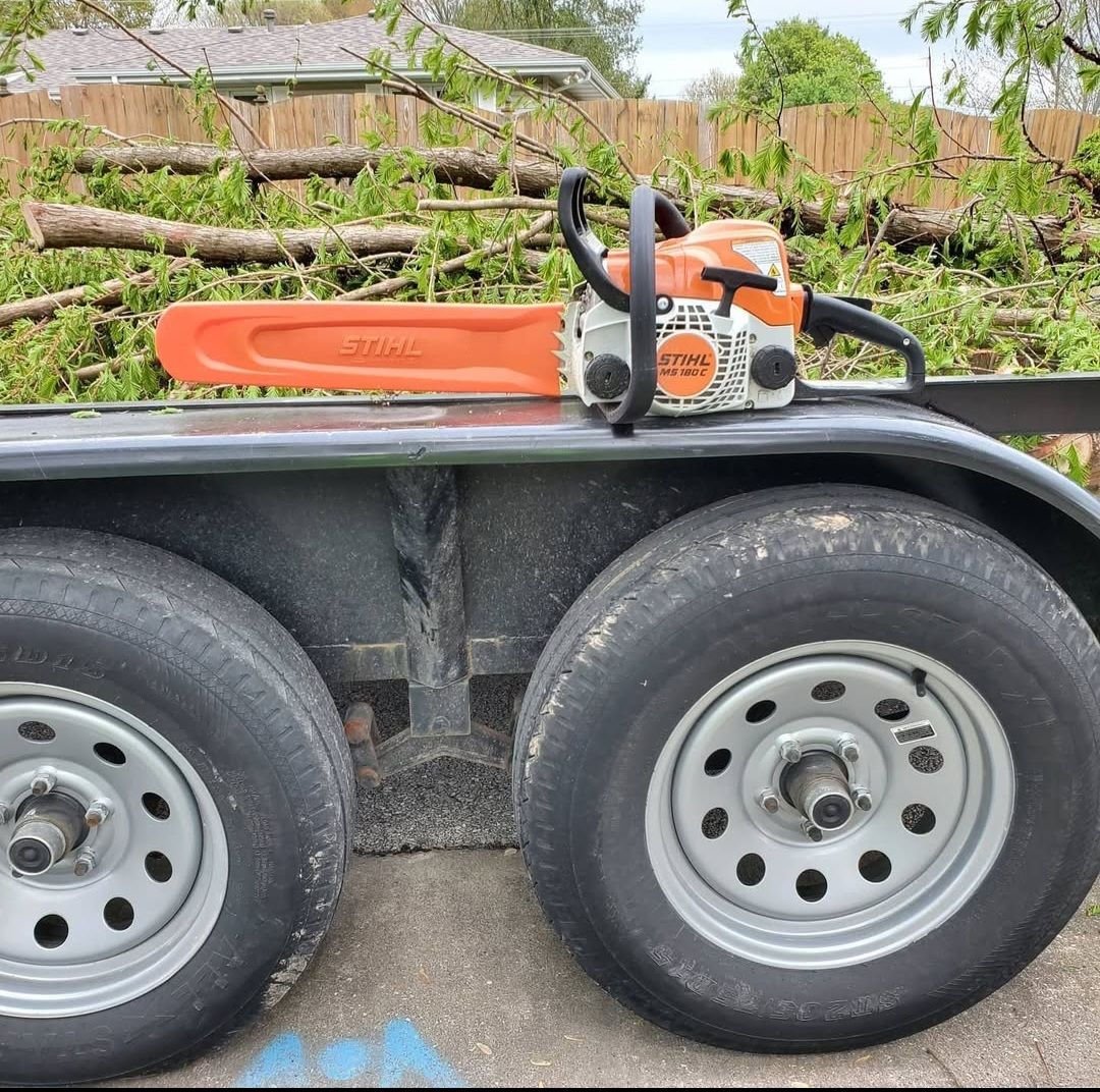 A chainsaw is sitting on top of a trailer.