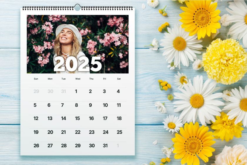 A calendar with flowers on a wooden table