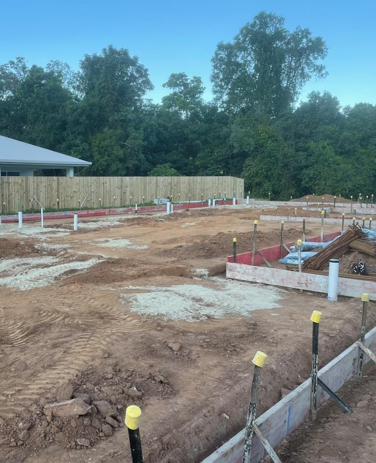 A Construction Site With A House In The Background — Russell Plumbing In Manunda, QLD