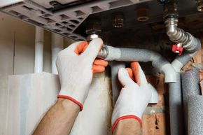 technician insulates the hot water heater