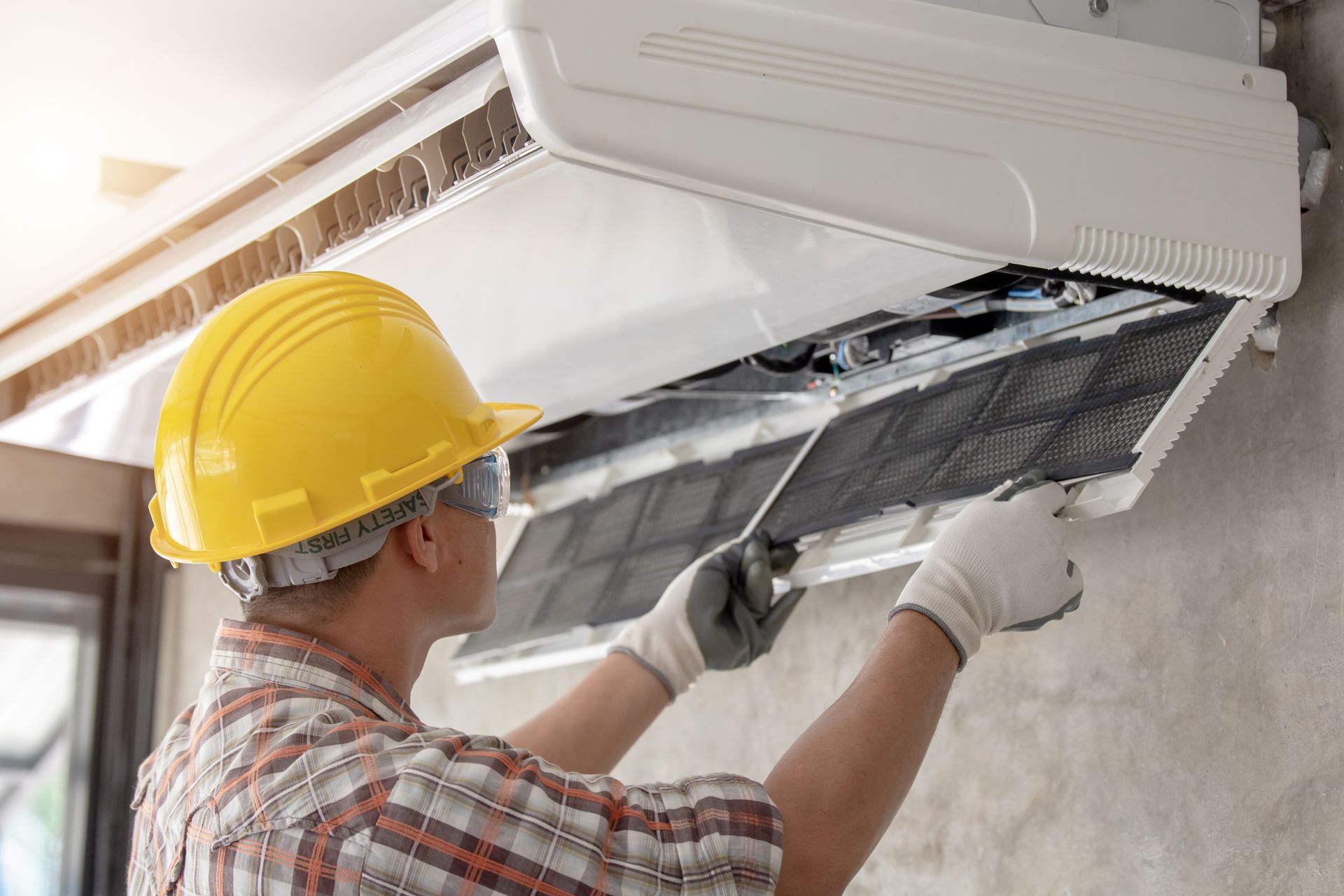 technician is installing air conditioner