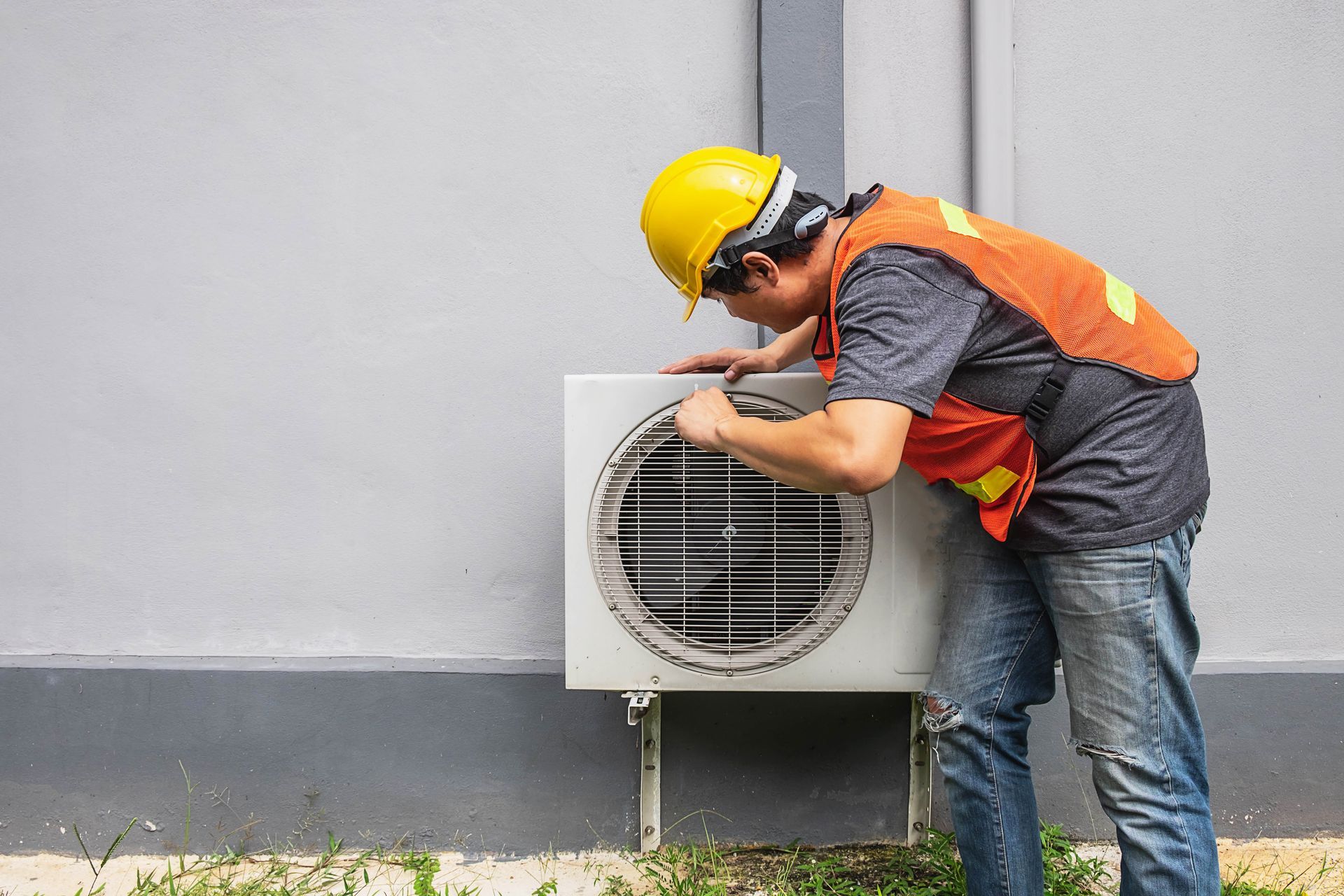 technician is fixing air conditioner