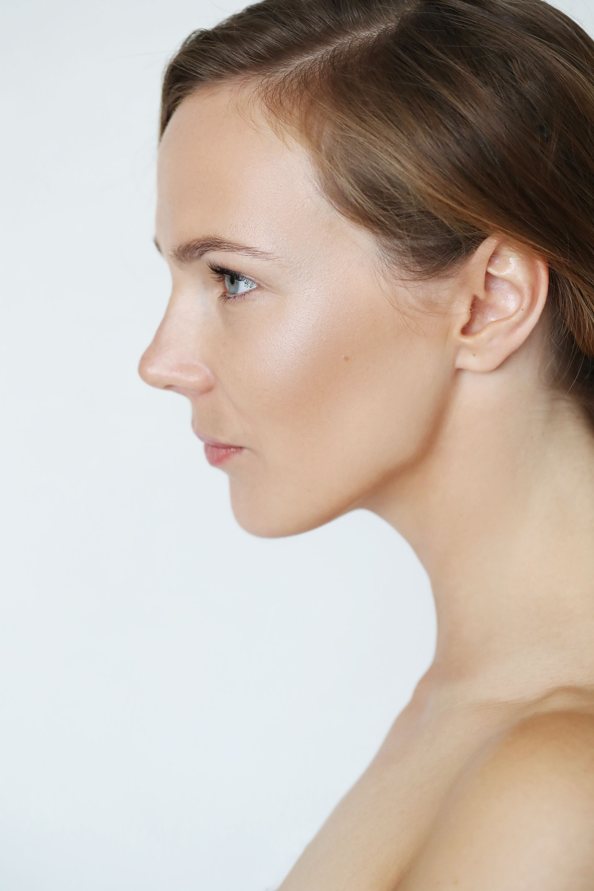 A close up of a woman 's face with a white background.