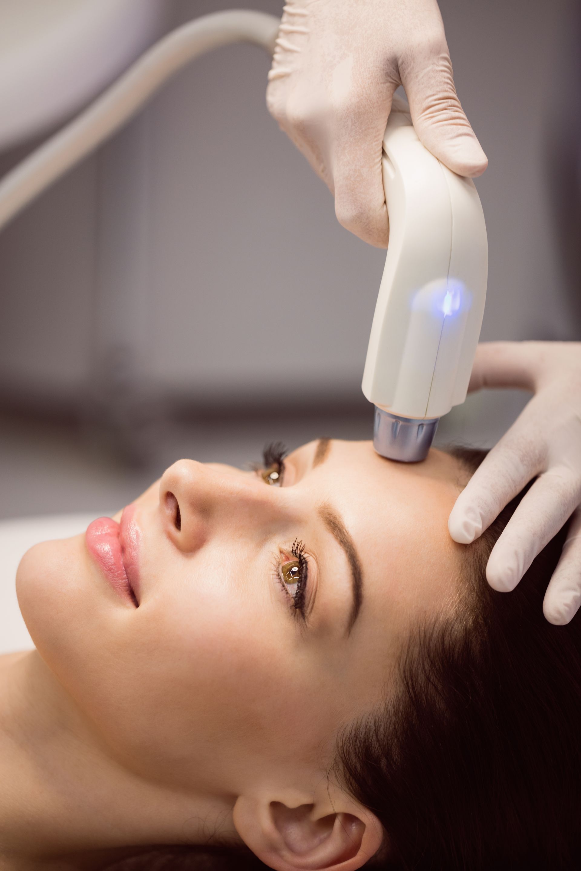 A woman is getting a facial treatment at a beauty salon.