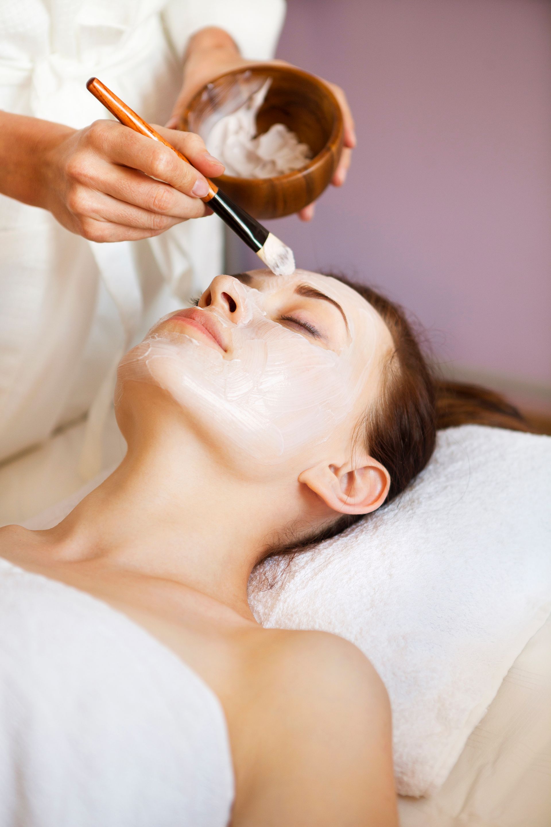 A woman is getting a facial treatment at a spa.