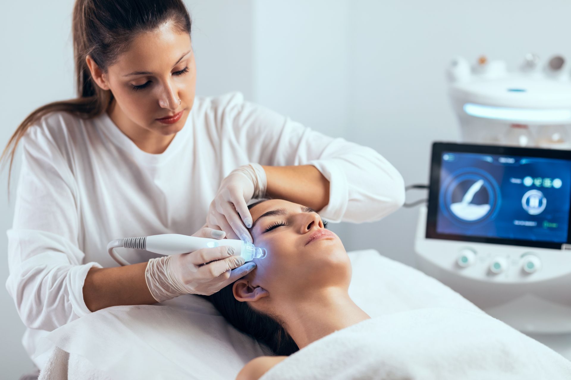 A woman is getting a facial treatment at a beauty salon.