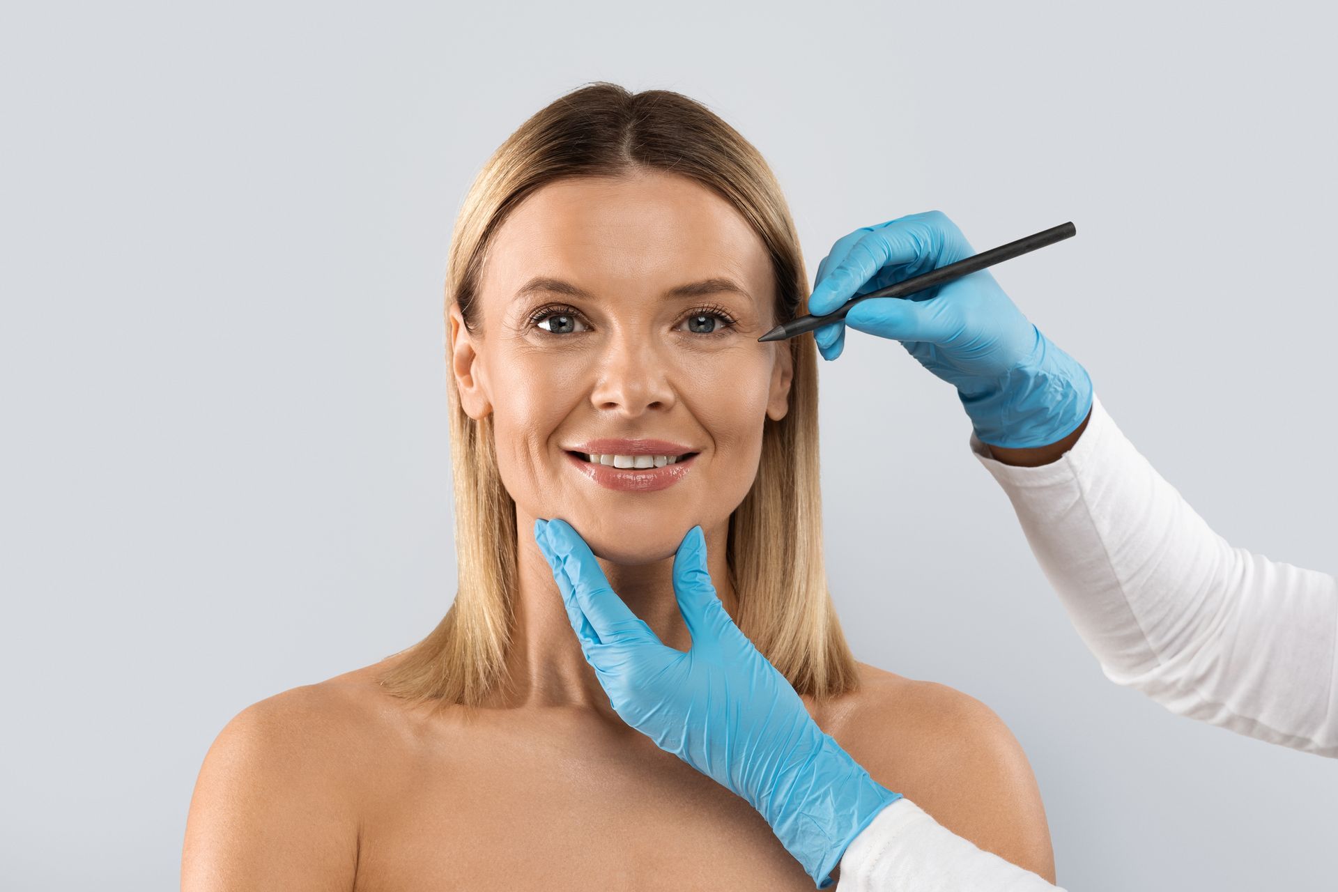 A woman is getting her face examined by a doctor.