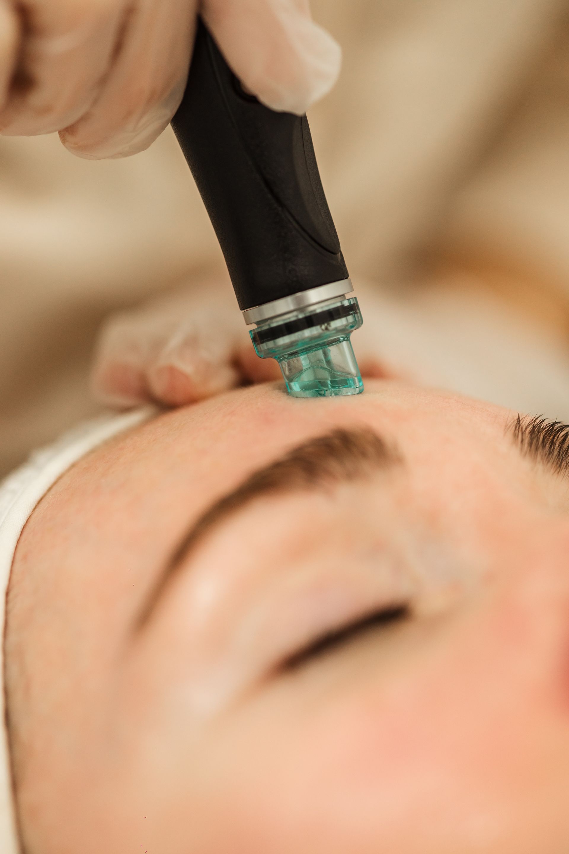 A woman is getting a facial treatment at a beauty salon.