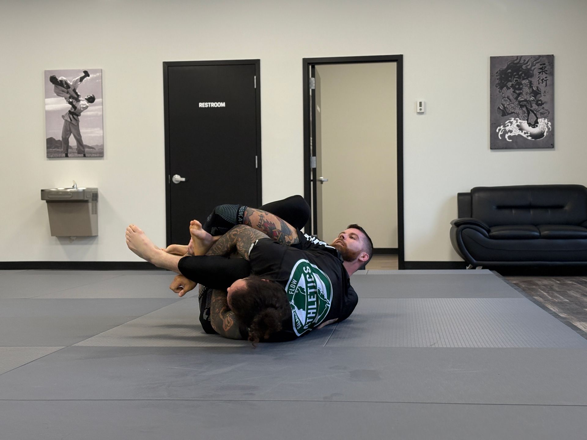 Adults practicing Brazilian Jiu-Jitsu self-defense techniques at Rival Jiu-Jitsu studio in Waldwick.