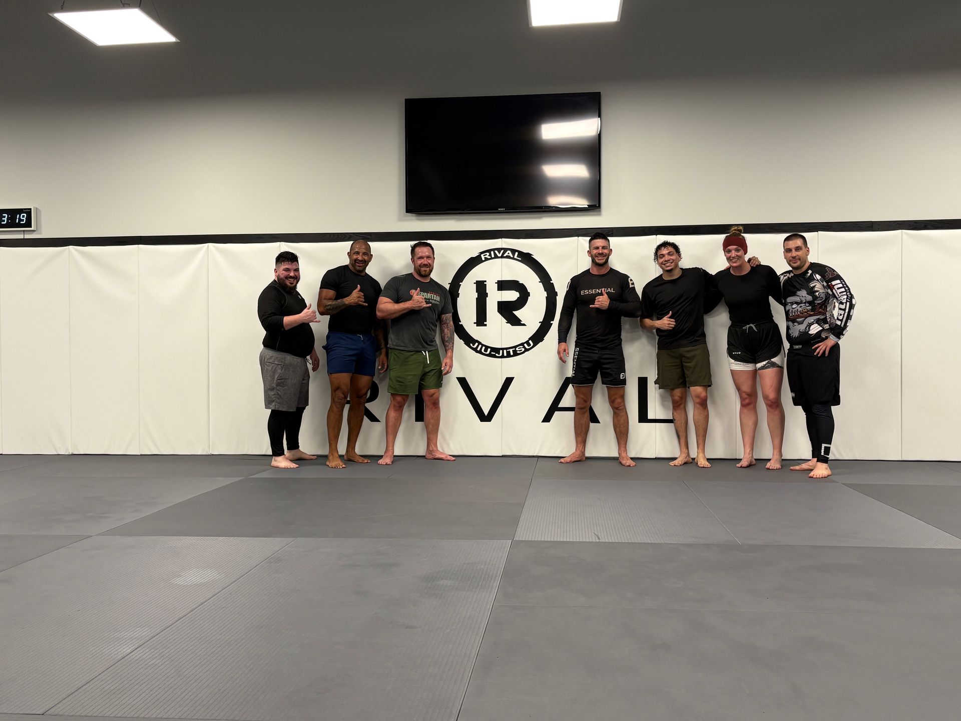 Adults practicing Brazilian Jiu-Jitsu self-defense techniques at Rival Jiu-Jitsu studio in Waldwick.
