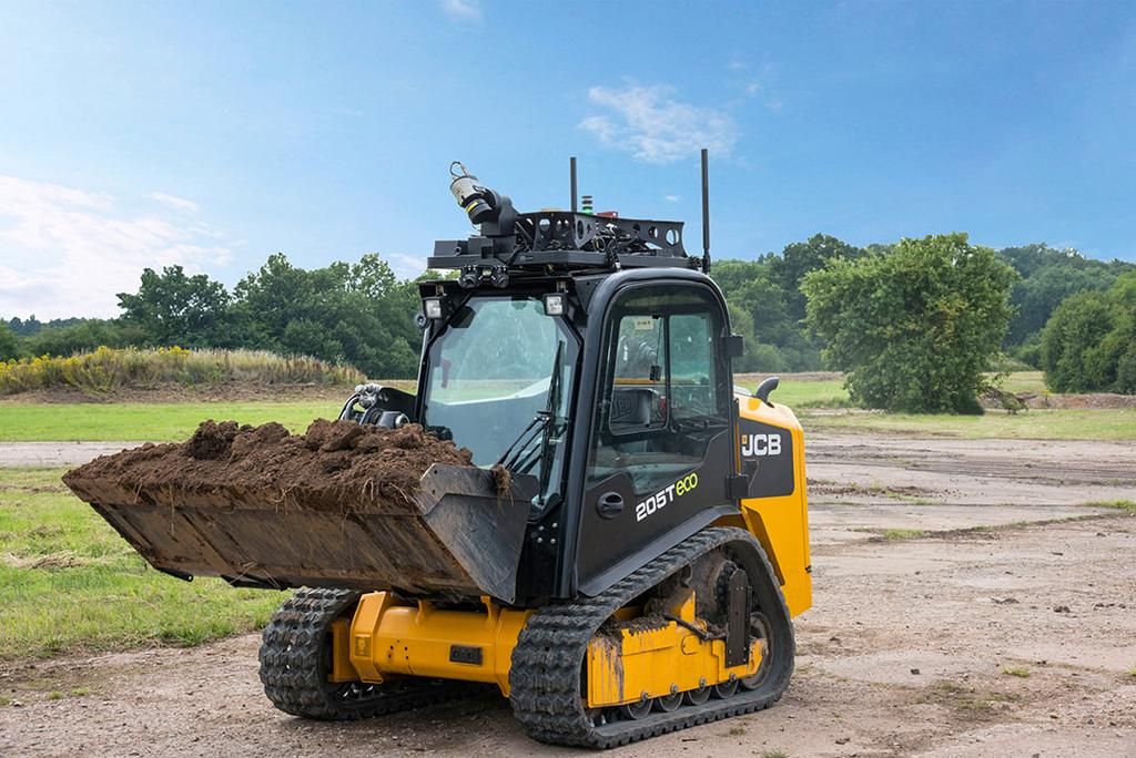 Skid steer is loading soil into its bucket