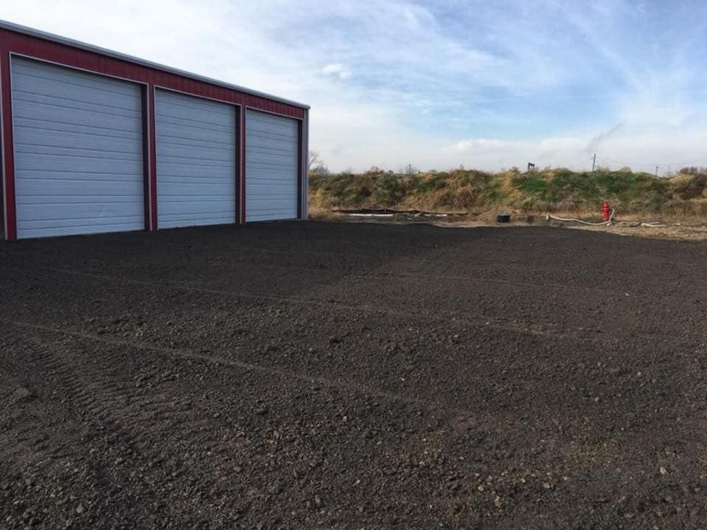 A row of garage doors are lined up in a parking lot.