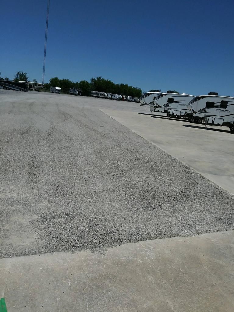 A lot of rv 's are parked in a parking lot