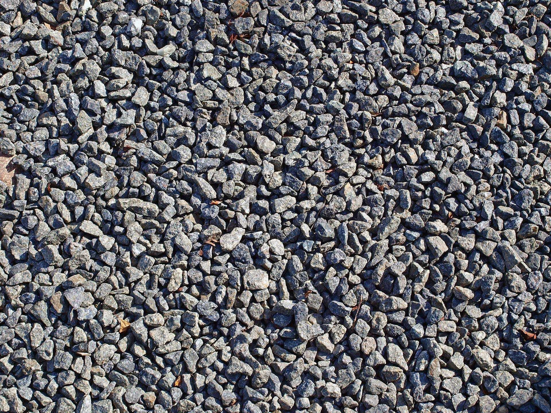 A pile of gravel is sitting on the ground.