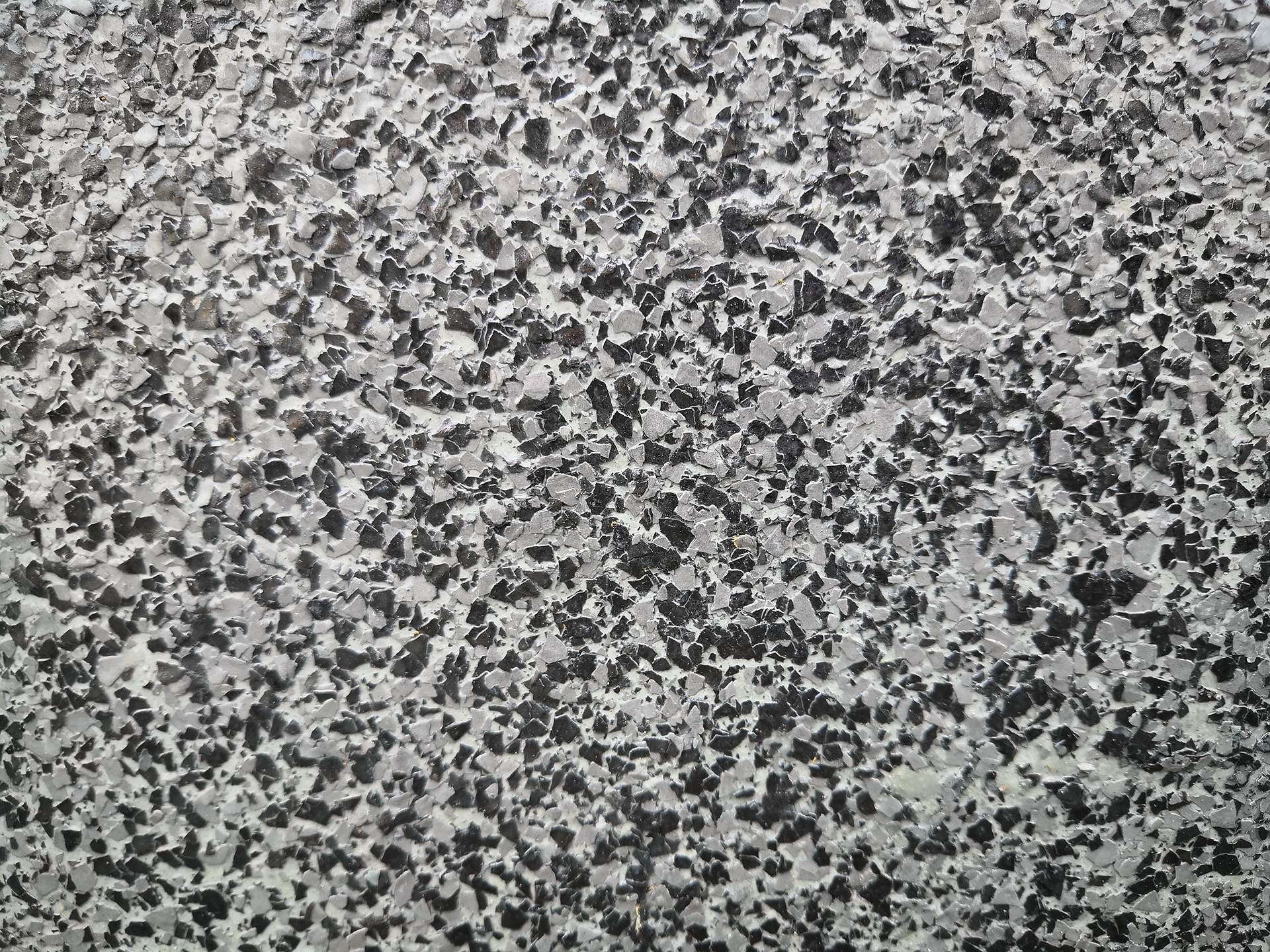 A close up of a black and white granite counter top.