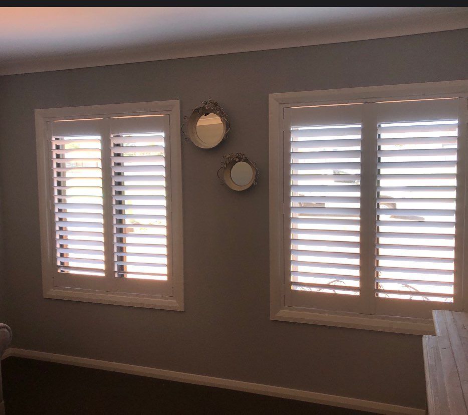 A Bedroom with Two Windows with Shutters and Two Mirrors on The Wall — Douglass Blinds & Security Screens in Yass, NSW