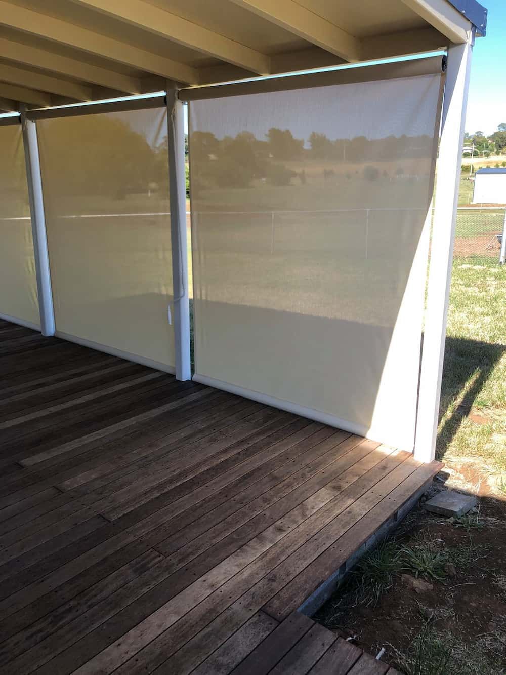 A Wooden Deck with Blinds on The Side of It — Douglass Blinds & Security Screens in Crookwell, NSW