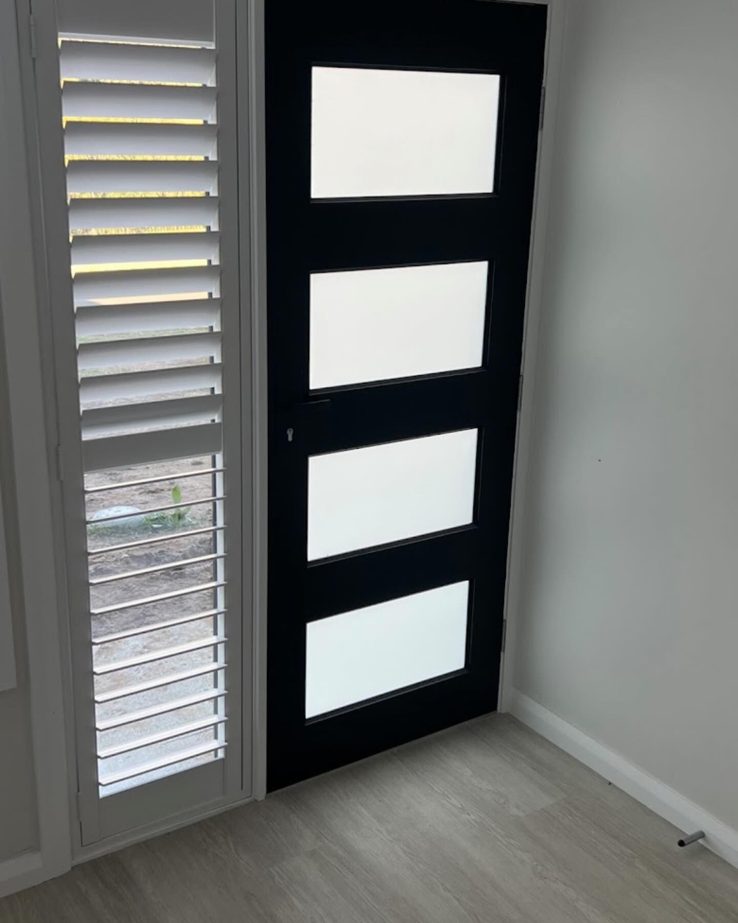 A Front Door with Shutter Blinds next to it— Douglass Blinds & Security Screens in Southern Highlands, NSW