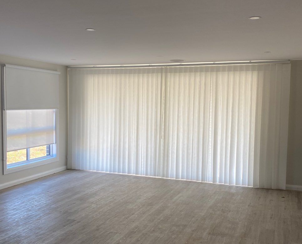 A empty lounge with White Curtains — Douglass Blinds & Security Screens in Goulburn, NSW