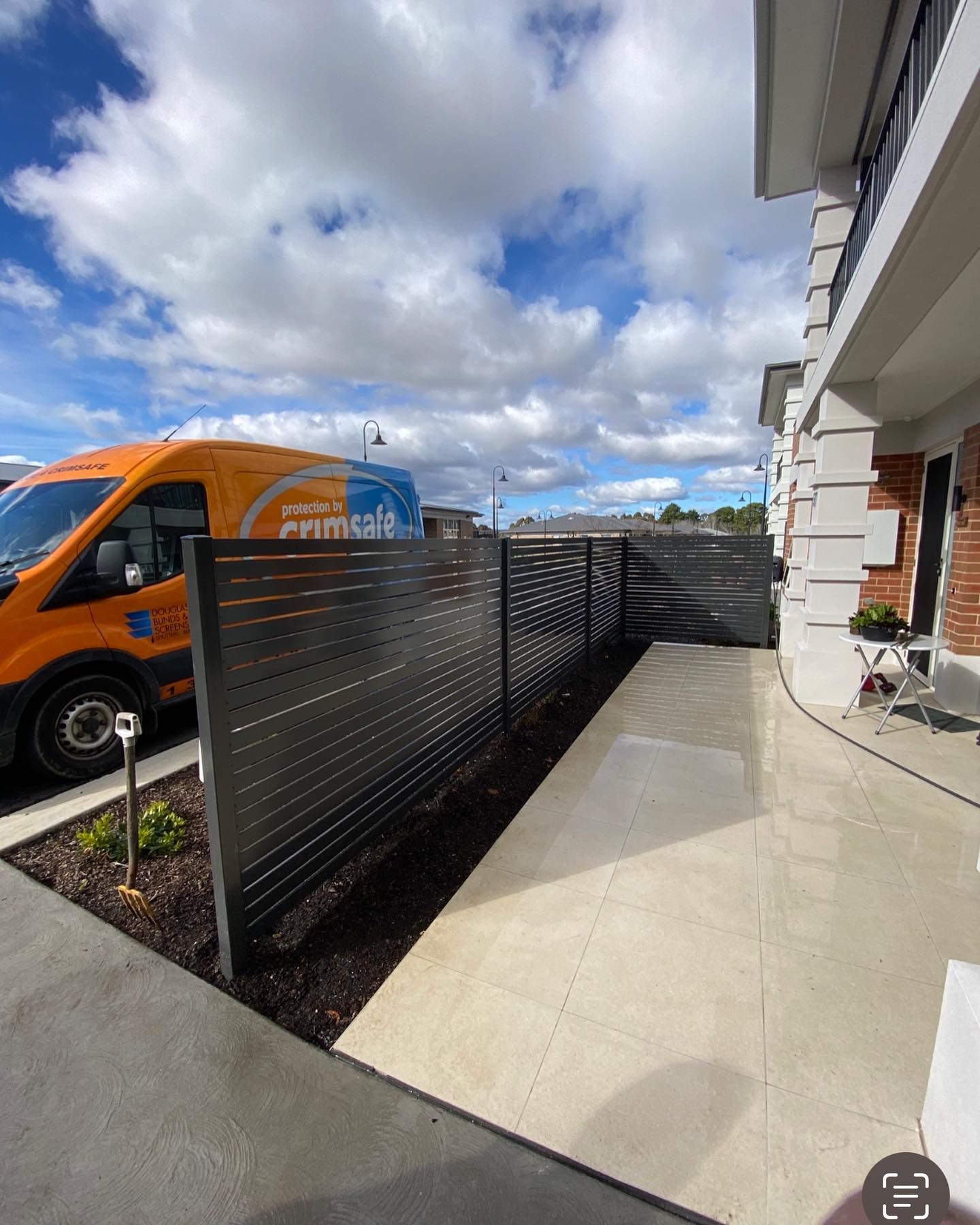 Outside of a House with Front Garden and An Aluminium Fence and A Van parked out the front— Douglass Blinds & Security Screens in Goulburn, NSW