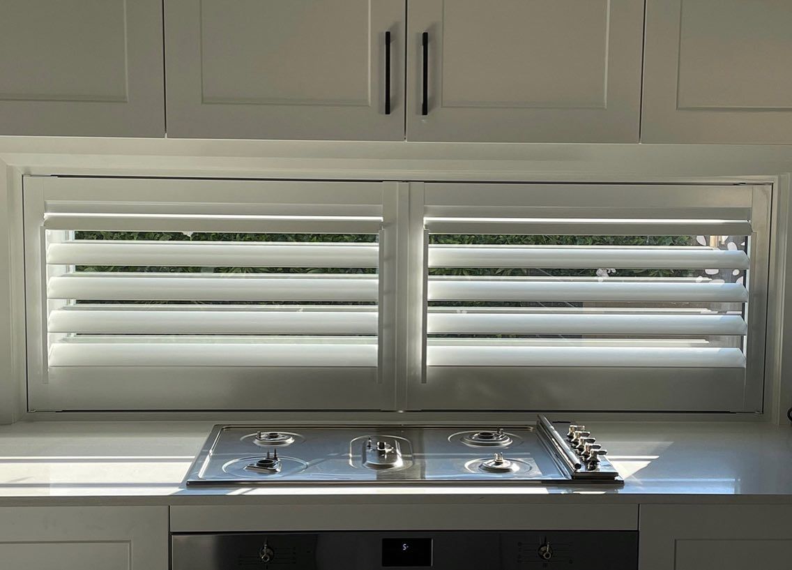 A Kitchen with Shutters over the Window— Douglass Blinds & Security Screens in Burradoo, NSW