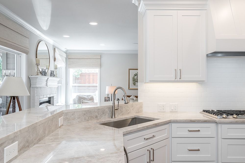 a kitchen with white cabinets and a sink