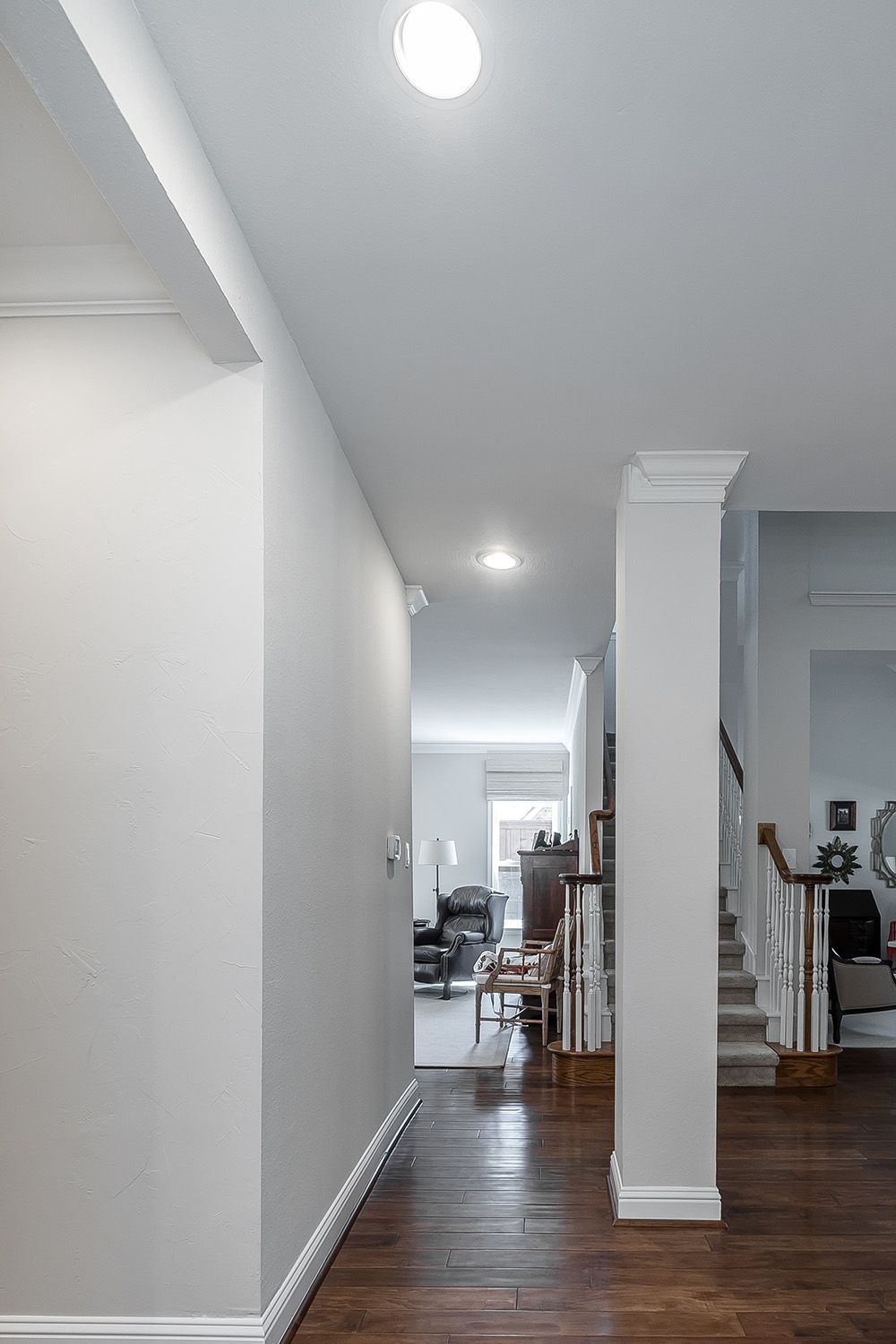 a hallway leading to a living room and stairs