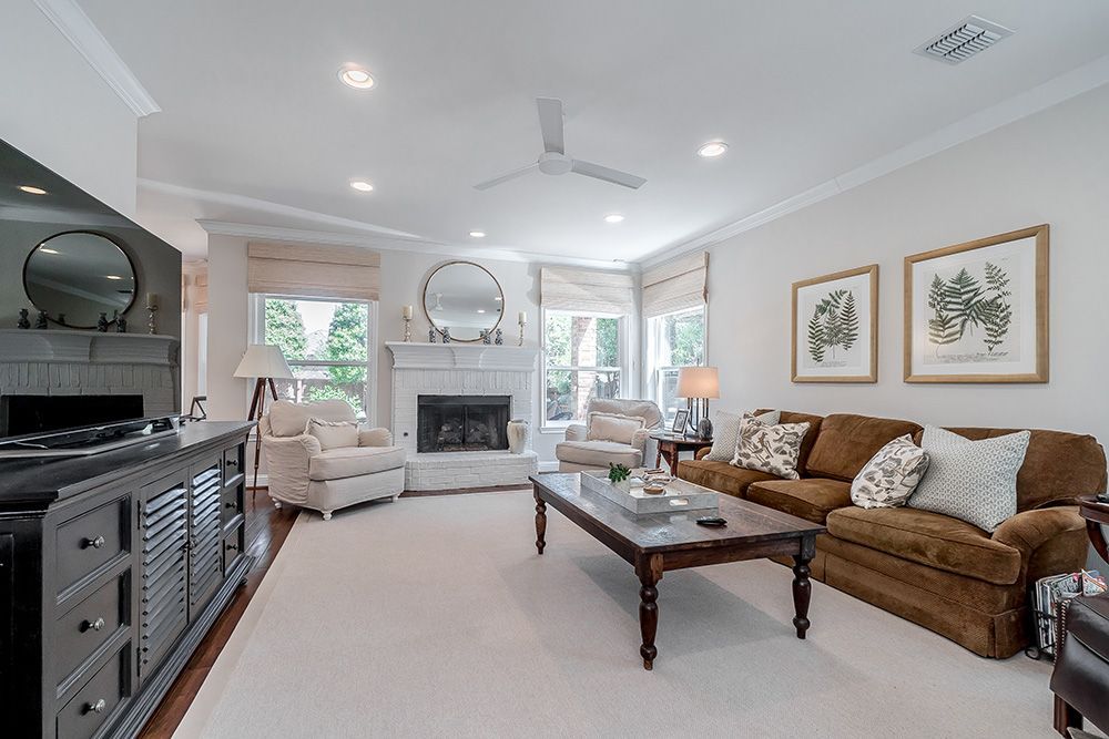 a living room with a couch and chairs and a fireplace