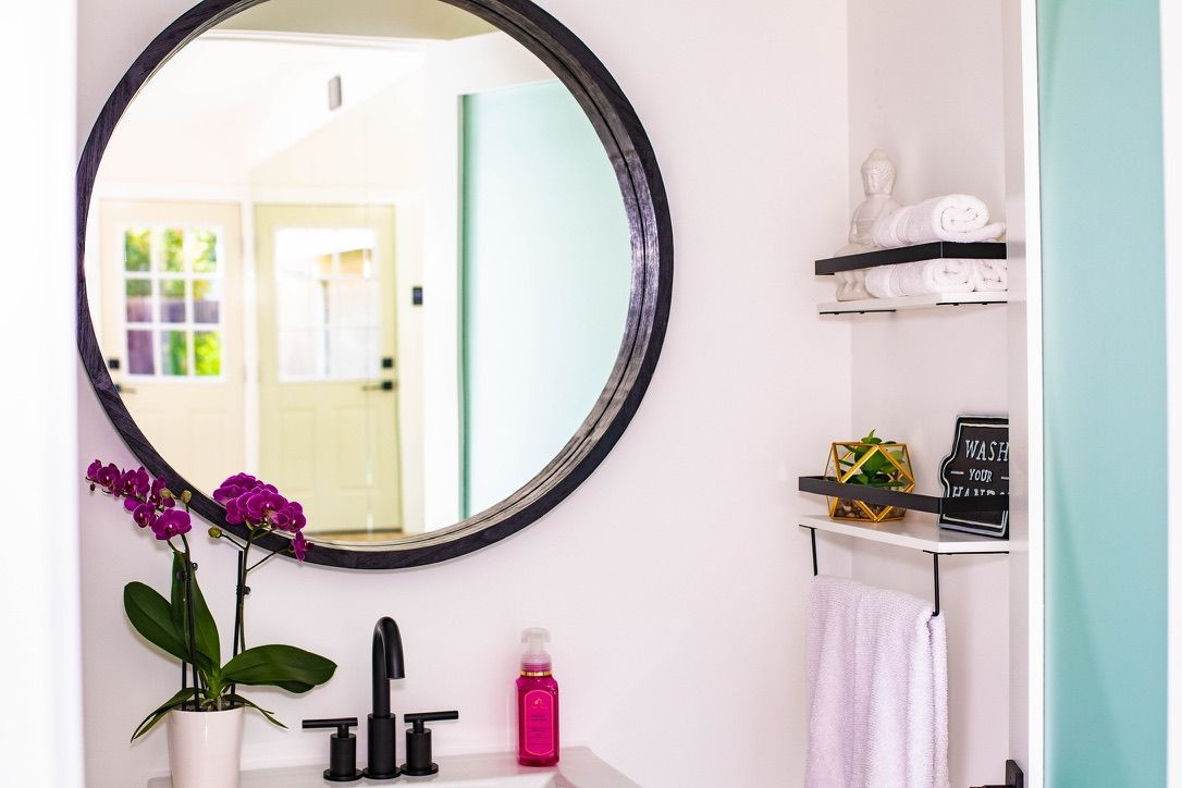 Beautiful bathroom decor in the Pilates by Eve guest restroom for clients while in the studio.