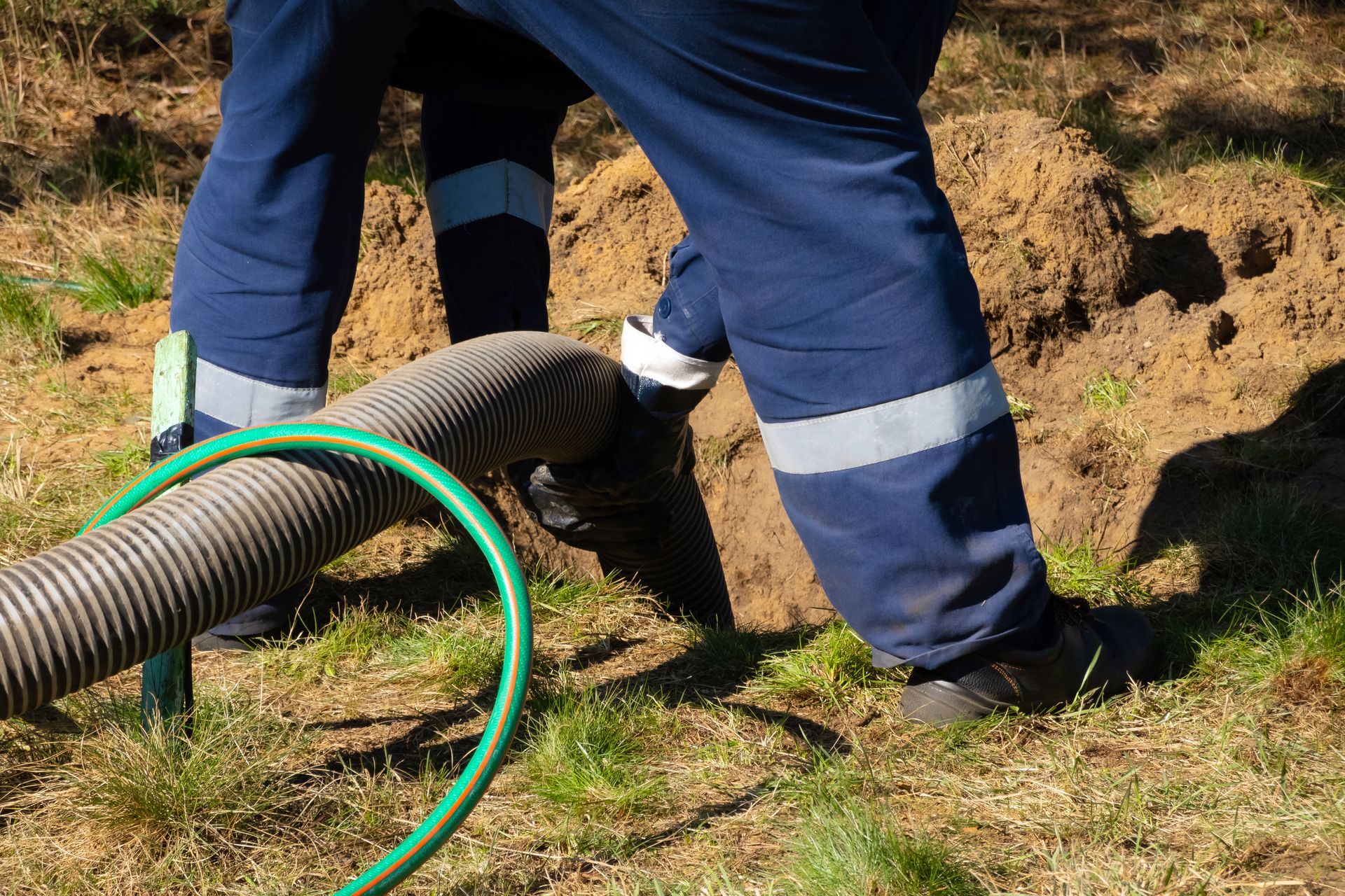 A man is cleaning a septic tank.